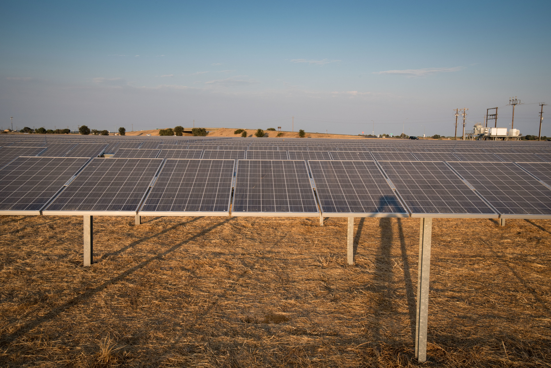Rangées de panneaux photovoltaïques d'une centrale solaire au soleil couchant